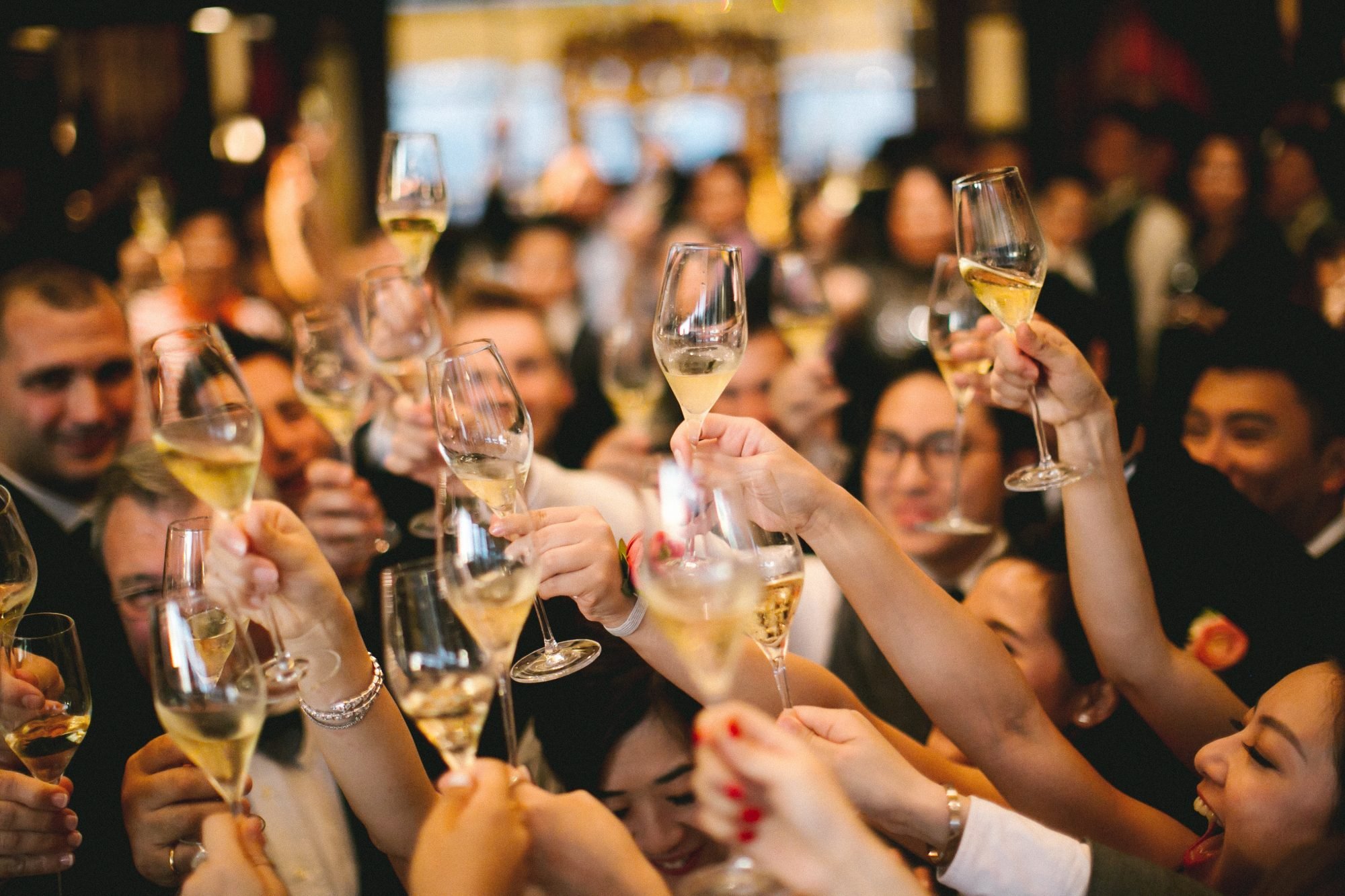 Celebrations Guests raising champagne glasses in celebration